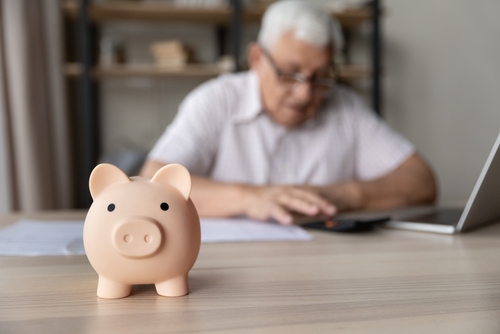 Ceramic,Pink,Piggy,Bank,Close,Up,On,Desk,Of,Elderly