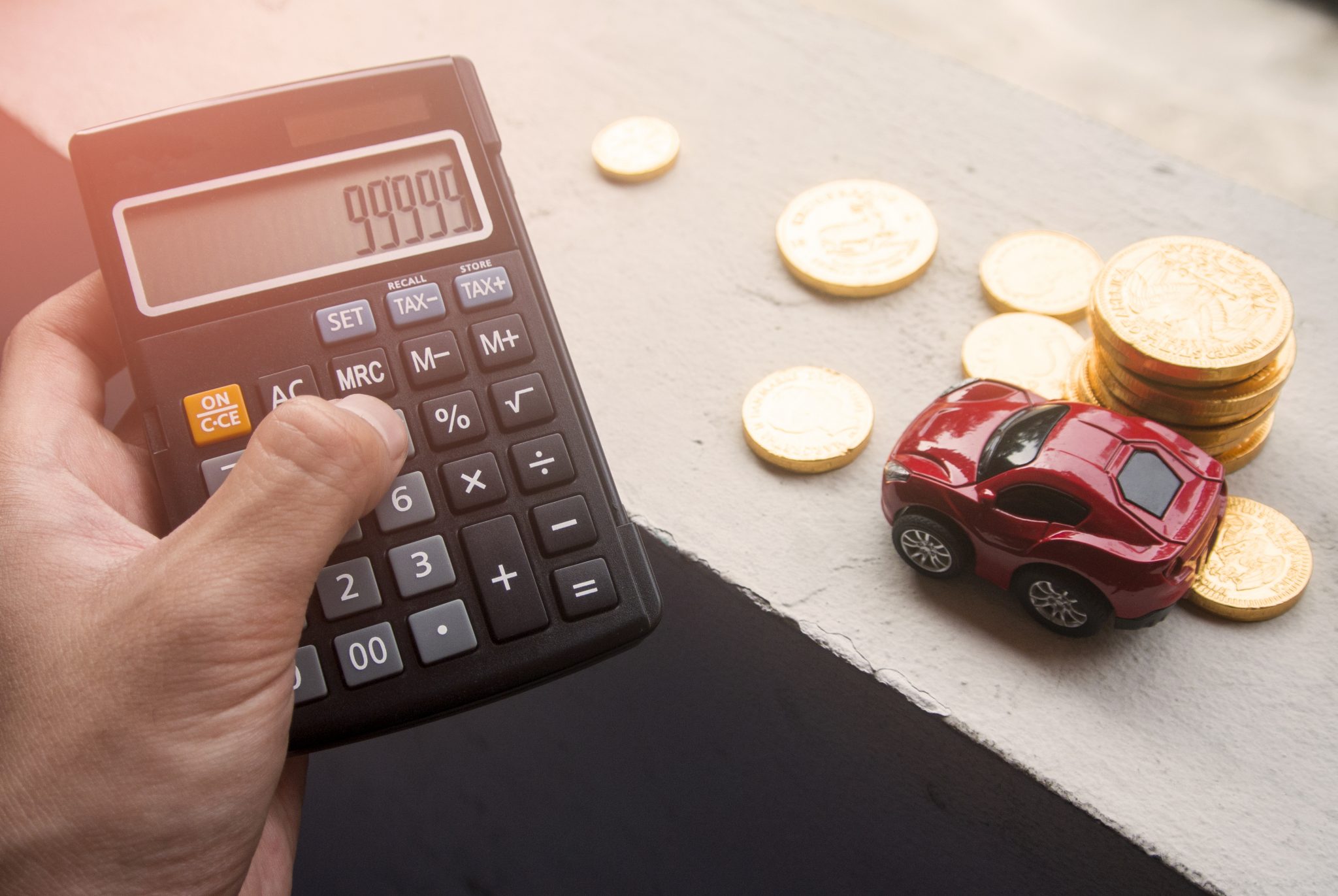 Hand,Pick,The,Calculator,And,Car,With,Coin,Money