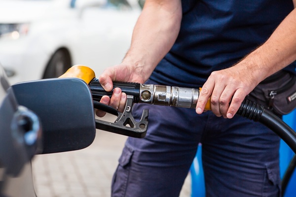 Gas,Station.,Gasoline,Filling,A,Car.,A,Man,Holds,A