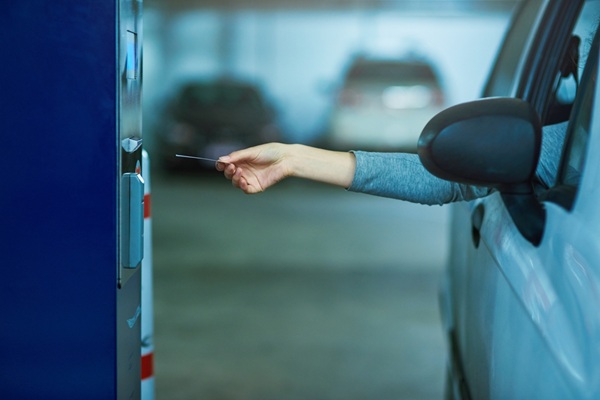 Parking,Lot,,Car,And,Hand,With,Ticket,Meter,For,Payment,