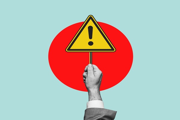 Warning,Sign.,Hand,Holding,A,Warning,Sign,,Alarm,Message,,Caution,