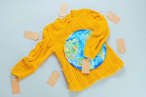 A,Yellow,Knitted,Sweater,With,A,Painted,Planet,Earth,On