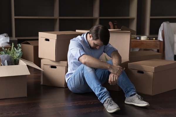 Upset,Frustrated,Man,Sit,On,Floor,Near,Heap,Of,Stacked