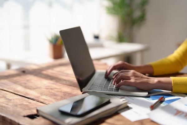 Person,Hands,Wearing,A,Yellow,Sweater,Typing,On,A,Laptop