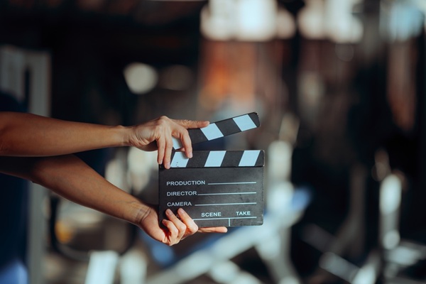 Director,Holding,A,Film,Slate,In,A,Gym,Movie,Set.