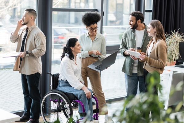 Cheerful,Interracial,Business,People,And,Disabled,Woman,In,Wheelchair,Using